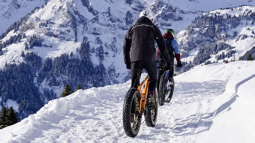 Image of people mountain biking in snow